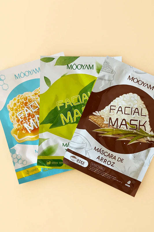 Three facial mask packages from Mooyam on a beige background