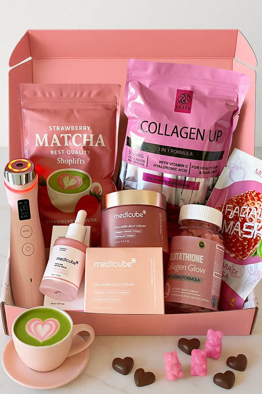 Pink beauty box with skincare products, a cup of matcha, and other items on a white background